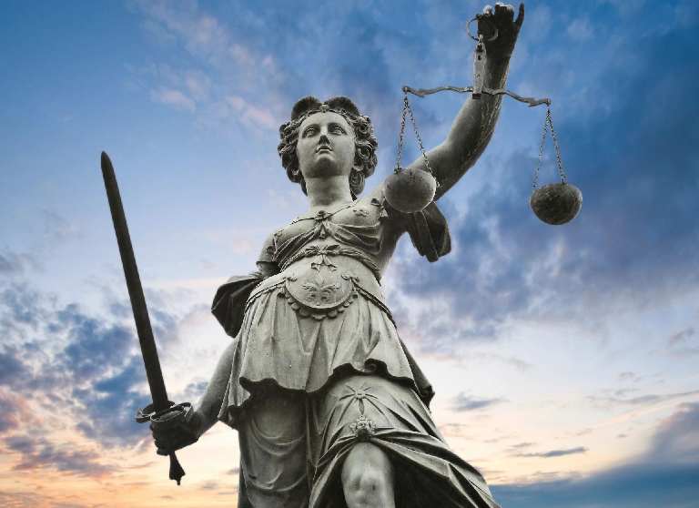 A statue of lady justice holding the scales and sword.